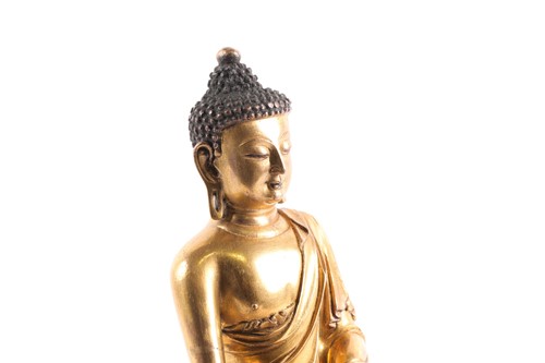 Lot 249 - A Chinese gilt bronze buddha, Qing, seated in...
