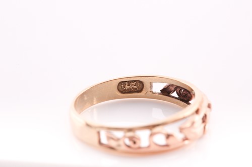 Lot 234 - A 9 ct and rose gold Clogau band ring, size Q,...