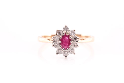 Lot 35 - A ruby and diamond cluster ring set in yellow...