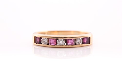 Lot 201 - A ruby and diamond half hoop ring, channel set...