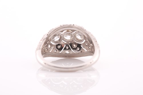 Lot 235 - A platinum and diamond bombe ring, with a...