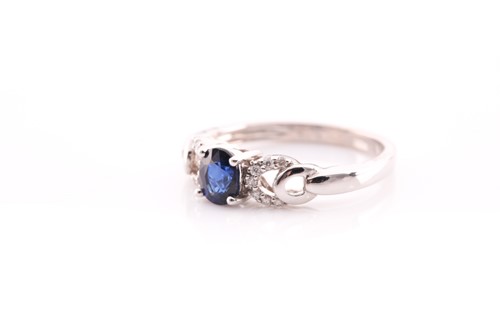 Lot 28 - A sapphire and diamond ring; the central oval...