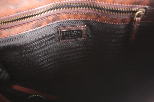 Lot 262 - A Prada brown leather handbag with chrome...