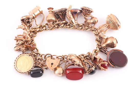 Lot 81 - A 9ct gold curb link charm bracelet on a...