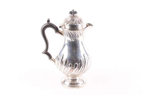 Lot 325 - A late Victorian silver baluster hot water jug,...