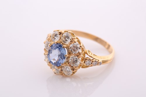 Lot 152 - A modern sapphire and diamond oval cluster...
