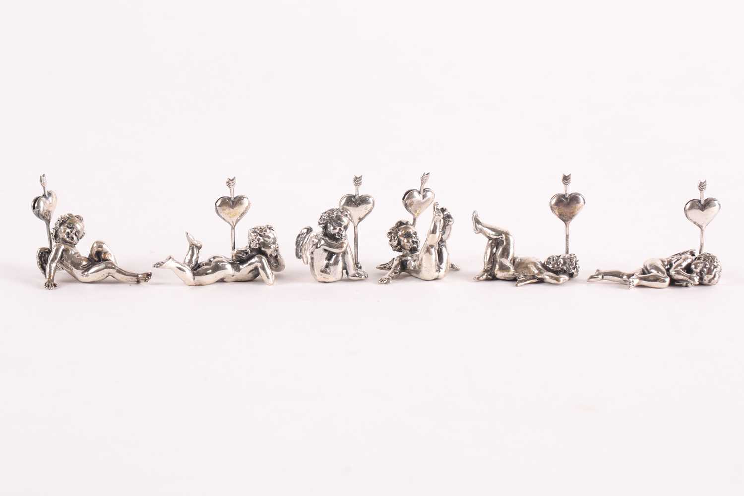 Lot 313 - A set of six modern cast silver cherub name...