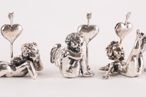 Lot 313 - A set of six modern cast silver cherub name...