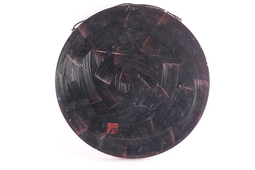 Lot 259 - A Japanese lacquered wood circular plaque,...