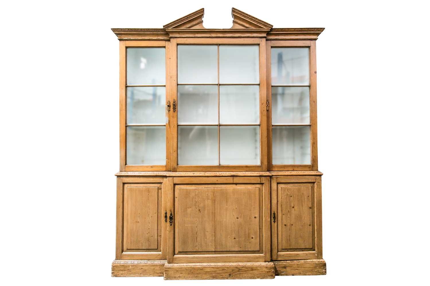 Lot 109 - A George III pine breakfront cupboard bookcase...