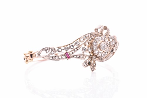 Lot 430 - A late Victorian diamond and ruby bangle, the...