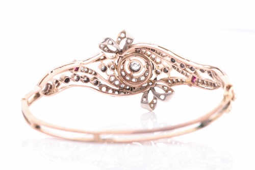 Lot 430 - A late Victorian diamond and ruby bangle, the...