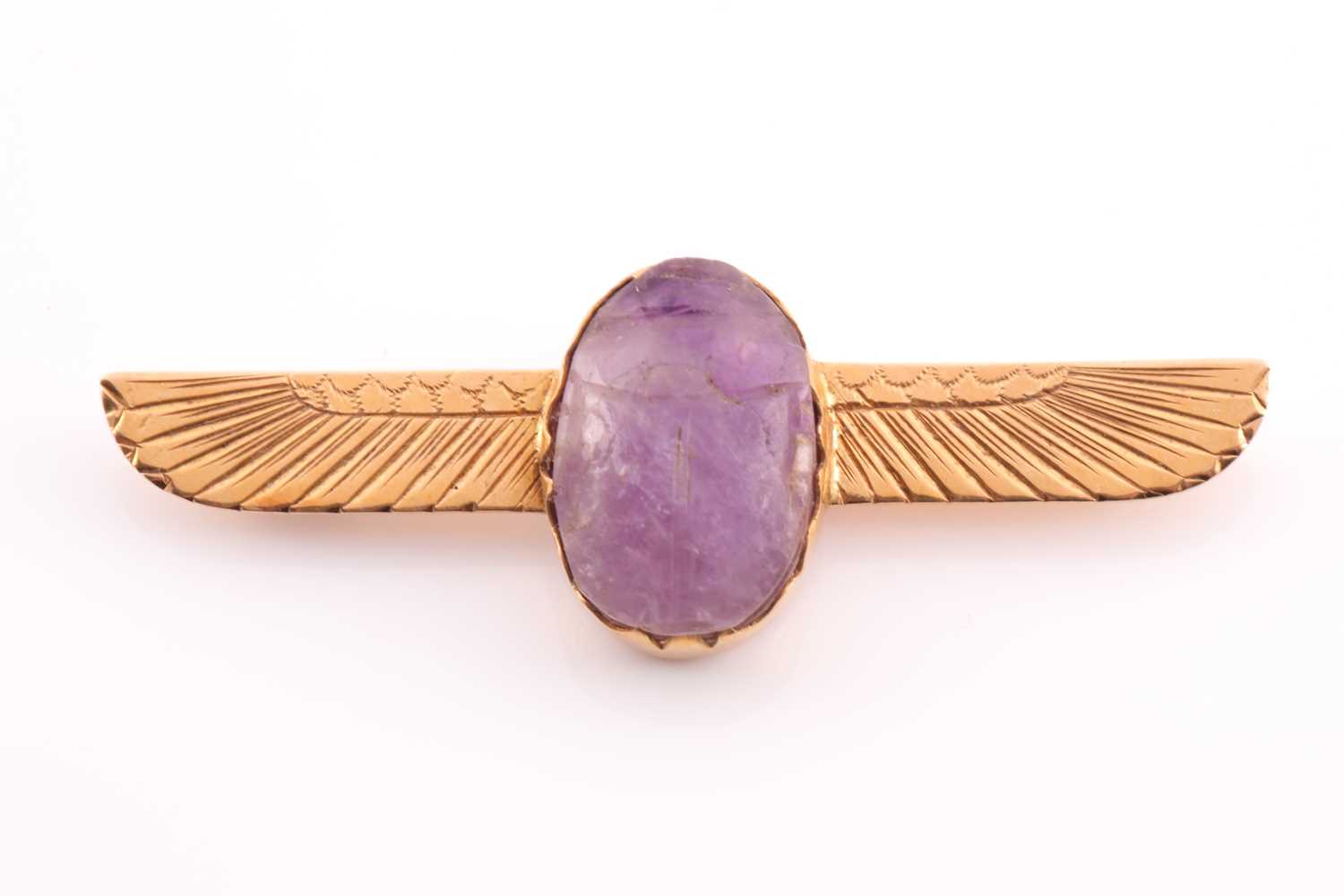 Lot 106 - A yellow metal and amethyst scarab brooch, set...