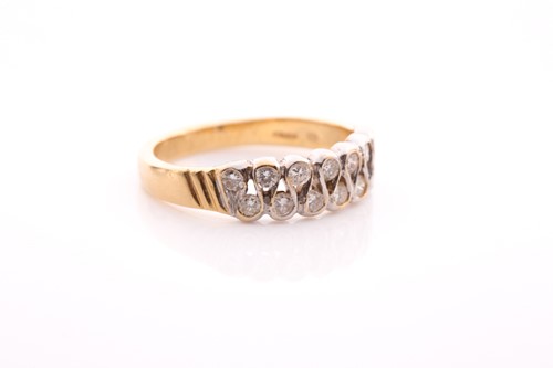 Lot 62 - A two row 18 carat gold and diamond half hoop...
