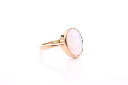 Lot 42 - A single stone opal ring, the oval opal in rub-...