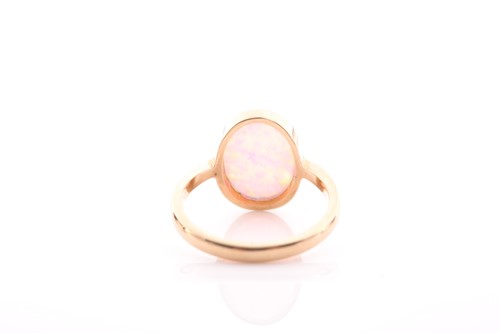 Lot 42 - A single stone opal ring, the oval opal in rub-...