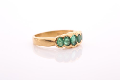 Lot 211 - A five stone half hoop emerald ring, the...