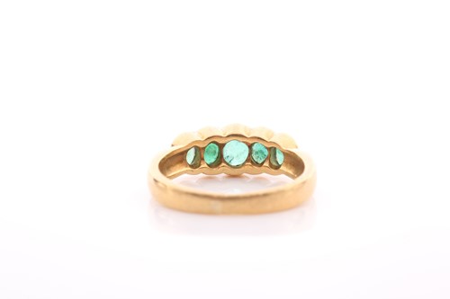 Lot 211 - A five stone half hoop emerald ring, the...