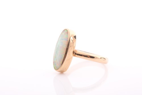 Lot 154 - A single stone opal ring, the elongated oval...