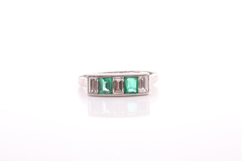 Lot 212 - A five stone half hoop emerald and diamond...