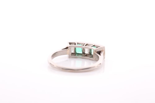 Lot 212 - A five stone half hoop emerald and diamond...