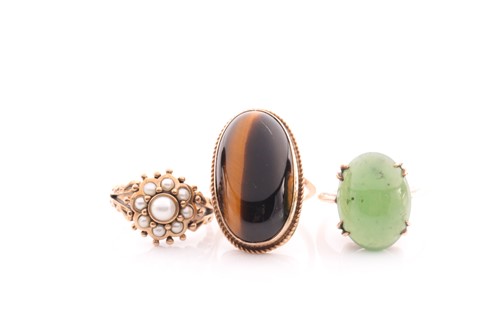 Lot 144 - A single stone jade ring; the oval stone in...