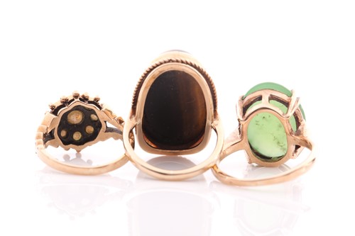 Lot 144 - A single stone jade ring; the oval stone in...