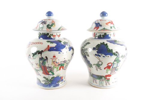 Lot 267 - A pair of Chinese Wucai vases and covers, Qing,...