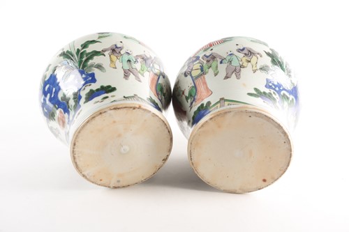 Lot 267 - A pair of Chinese Wucai vases and covers, Qing,...