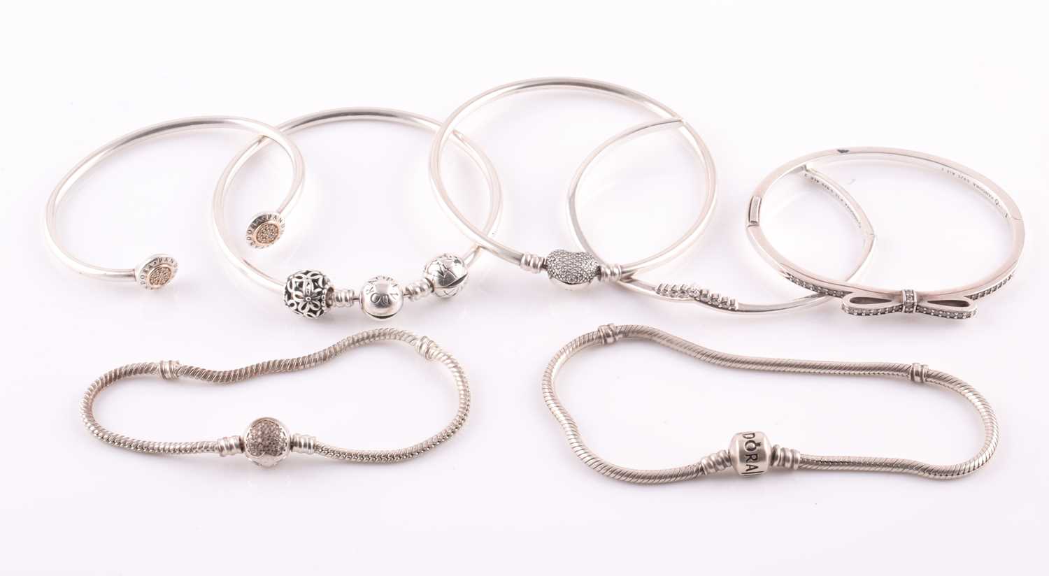 Lot 27 - A group of seven various white metal bangles...