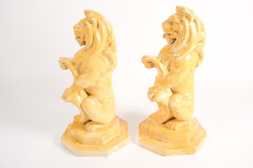 Lot 210 - A pair of composition heraldic lions, seated...