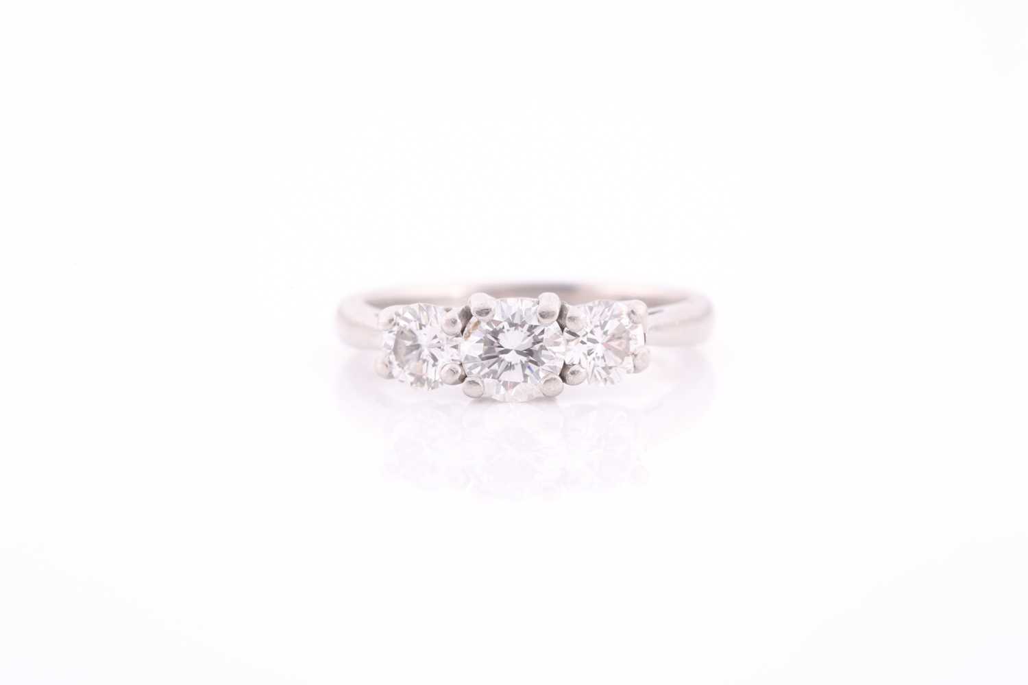 Lot 327 - A platinum and diamond ring, set with three...