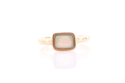 Lot 314 - An 18ct yellow gold and opal ring, the...