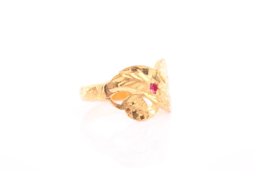 Lot 311 - An Indian yellow metal ring, with engraved...