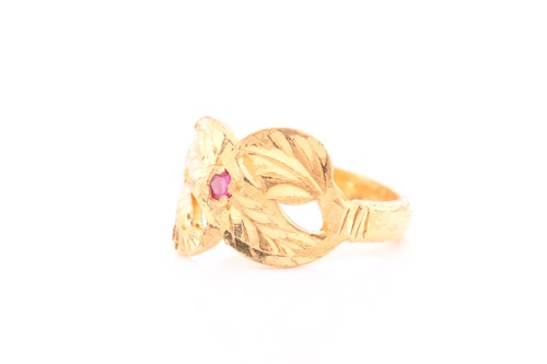 Lot 311 - An Indian yellow metal ring, with engraved...