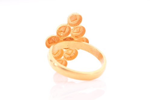 Lot 86 - An Indian yellow metal ring, the...