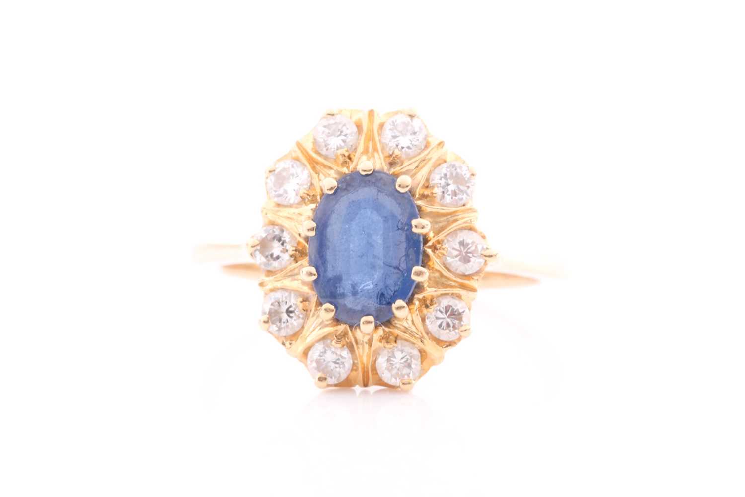 Lot 368 - A sapphire and diamond cluster ring; the oval...