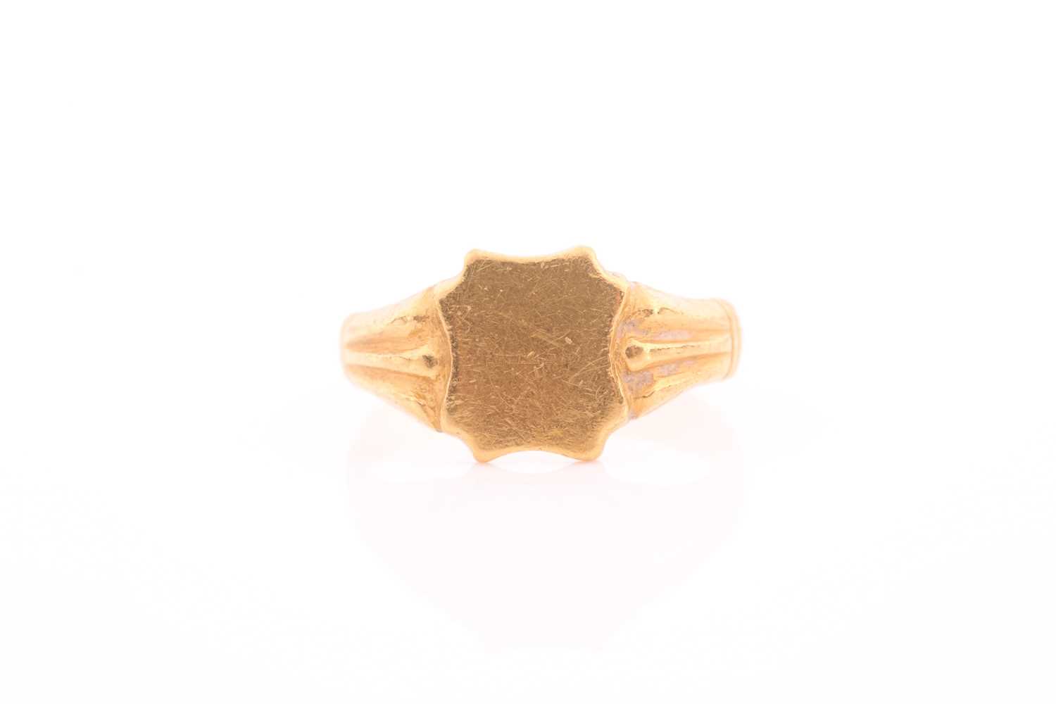 Lot 56 - A yellow metal signet ring, with shield-shaped...
