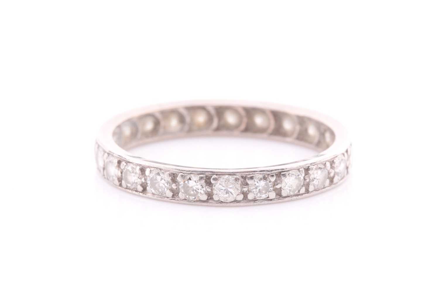 Lot 217 - A full hoop diamond eternity ring; the round...