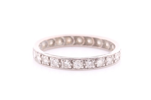 Lot 217 - A full hoop diamond eternity ring; the round...