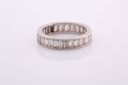 Lot 253 - A white metal and diamond eternity ring, set...