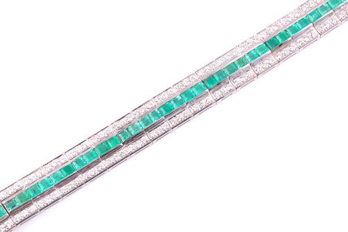 Lot 474 - An emerald and diamond line bracelet; composed...