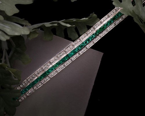 Lot 474 - An emerald and diamond line bracelet; composed...