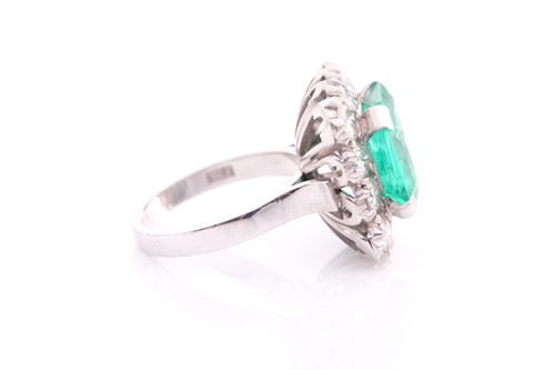 Lot 119 - An emerald and diamond cluster ring; the...