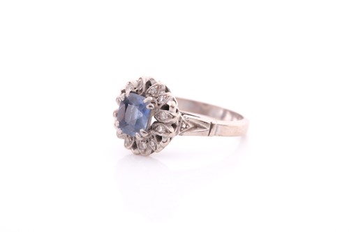 Lot 155 - A pale sapphire and diamond cluster ring, the...