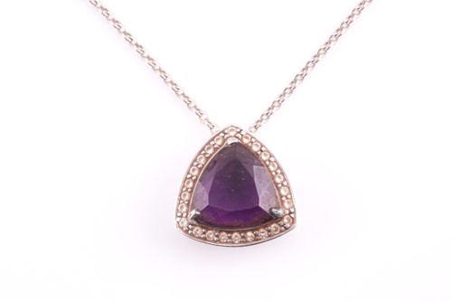 Lot 59 - An amethyst pendant and chain; the trillion...