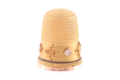 Lot 374 - A yellow metal thimble, with applied filigree...