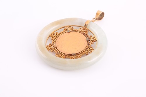 Lot 104 - A yellow metal and jade pendant, the pale...