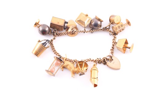 Lot 1 - A charm bracelet; the 9 carat gold curb...