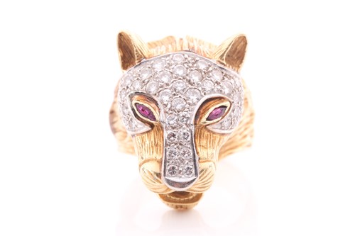 Lot 75 - A diamond and ruby set panther mask ring; the...
